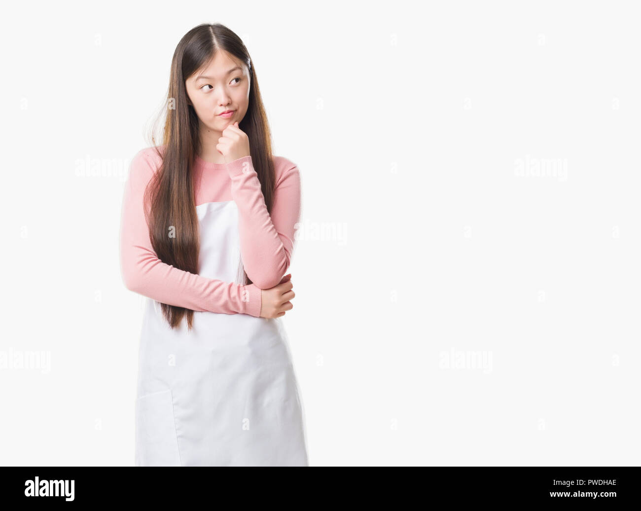 young-chinese-shop-owner-woman-over-isolated-background-wearing-white-apron-serious-face-thinking-about-question-very-confused-idea-PWDHAE